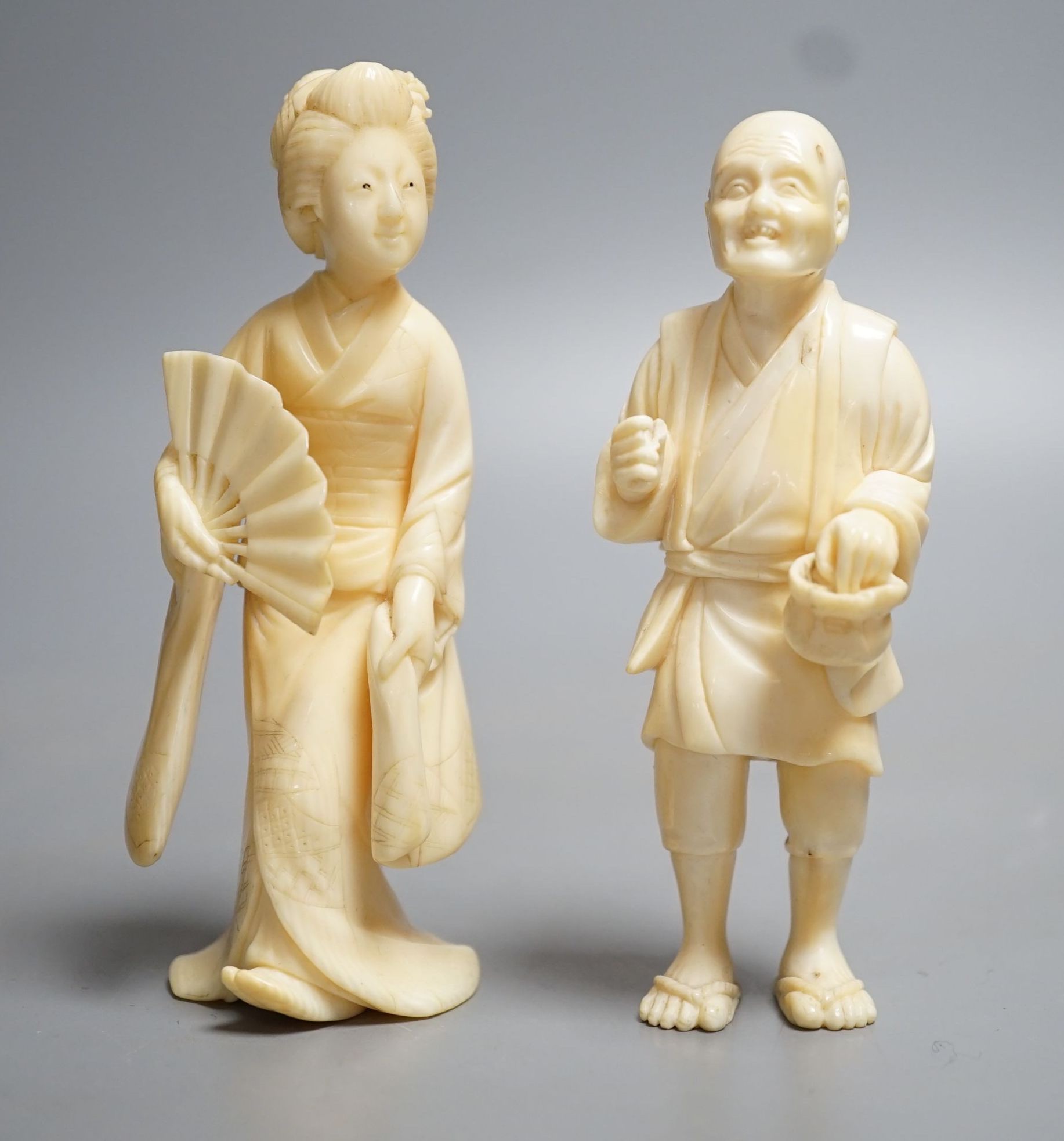 Two Japanese ivory figures of a man and a bijin, Meiji period, both signed to base, 10cm